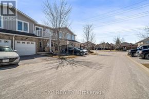 Barrie (Innis-Shore) townhouse for rent - A residential area with houses and cars parked in front.