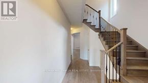 Shelburne apartment for rent - A hallway with a staircase and a brokerage sign.