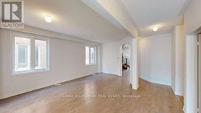 Shelburne apartment for rent - A spacious room with wooden floors and white walls, with a window on the left side.