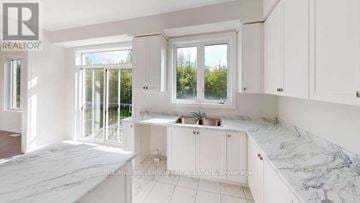 Shelburne apartment for rent - A kitchen with white cabinets and marble countertops.