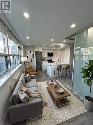 Toronto (Annex) multi-family for rent - A modern living room with a grey sofa and a wooden coffee table.
