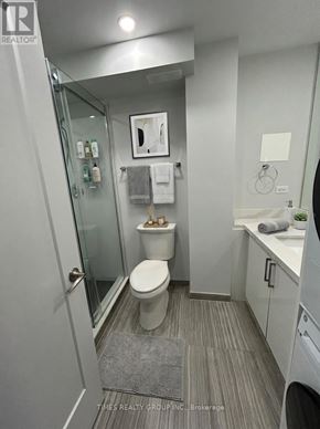 Toronto (Annex) multi-family for rent - A bathroom with a toilet, sink, and mirror.