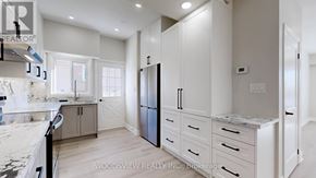 Toronto (Parkwoods-Donalda) apartment for rent - A kitchen with a marble countertop and a refrigerator.