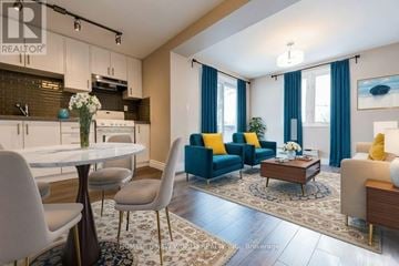 Toronto (The Beaches) apartment for rent - A well-lit living room with a dining table and chairs.