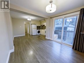 Toronto (The Beaches) apartment for rent - A spacious living room with a washer and dryer in the corner.