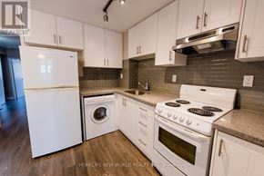 Toronto (The Beaches) apartment for rent - A kitchen with white appliances and cabinets.