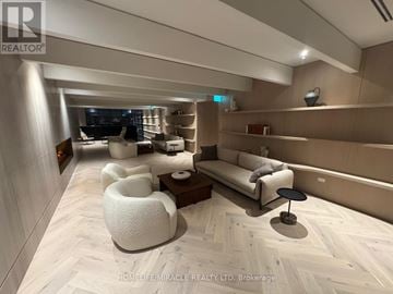Vaughan (Vaughan Corporate Centre) condo for rent - A modern living room with a white sofa and a wooden floor.