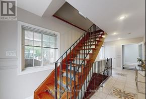 Brampton (Brampton West) apartment for rent - A staircase with a red carpeted runner leads up to a landing with a white door.