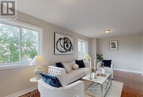 Brampton (Brampton West) apartment for rent - A living room with a white couch and a glass coffee table.