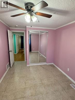 Mississauga (Malton) apartment for rent - A room with pink walls and a ceiling fan.