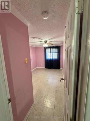 Mississauga (Malton) apartment for rent - A room with a ceiling fan and a window with curtains.