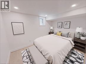 Kitchener apartment for rent - A bedroom with a large bed and two lamps on the nightstand.