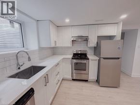 Kitchener apartment for rent - A kitchen with white cabinets and a stainless steel dishwasher.