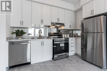 Mississauga (Churchill Meadows) townhouse for rent - A modern kitchen with white cabinets and stainless steel appliances.