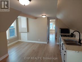 Hamilton (Gibson) apartment for rent - A kitchen with white cabinets and a wooden floor.