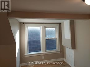 Hamilton (Gibson) apartment for rent - A room with a window and a sign that says EXP REALTY, Brokerage.