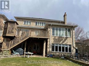 Toronto (Centennial Scarborough) apartment for rent - A house with a large deck and a patio table.