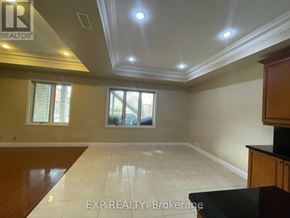 Toronto (Centennial Scarborough) apartment for rent - A spacious room with a large window and a tiled floor.