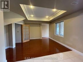 Toronto (Centennial Scarborough) apartment for rent - A room with wooden floors and a slanted ceiling.
