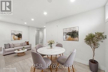 Toronto (Kingsview Village-The Westway) apartment for rent - A modern living room with a dining table set up with chairs and a potted plant.