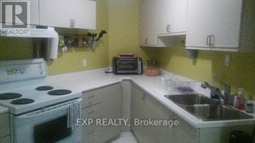 Brampton (Fletcher's West) apartment for rent - A kitchen with a stove, sink and cabinets.