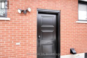 Ottawa apartment for rent - A black door is on a red brick wall.