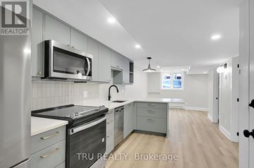 Ottawa apartment for rent - A modern kitchen with stainless steel appliances and a microwave above the stove.