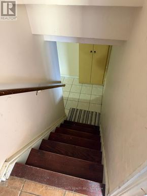 Toronto (Woburn) apartment for rent - A staircase with wooden steps and a white wall.