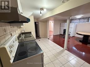 Toronto (Woburn) apartment for rent - A kitchen with a stove top oven and a refrigerator.