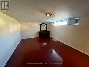 Toronto (Woburn) apartment for rent - A room with a wooden floor and a television set.