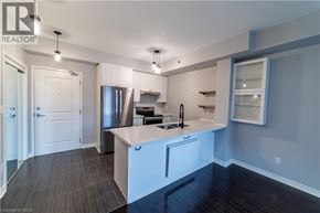 Burlington condo for rent - A kitchen with white cabinets and a stainless steel refrigerator.