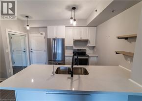Burlington condo for rent - A kitchen with a white counter top and stainless steel appliances.