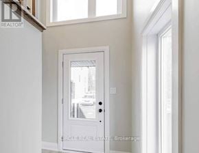 Innisfil (Lefroy) townhouse for rent - A white door with a glass window in the middle of a room.
