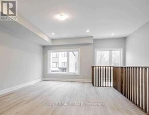 Innisfil (Lefroy) townhouse for rent - A spacious room with wooden flooring and a large window.