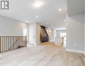 Innisfil (Lefroy) townhouse for rent - A spacious living room with a staircase leading to the upper floor.