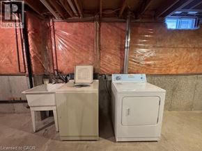 Waterloo apartment for rent - A room with a white desk and a white cabinet with a sign that says "REALTOR" on it.