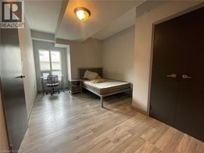 Waterloo condo for rent - A bedroom with a bed, desk, and chair.