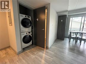 Waterloo condo for rent - A laundry room with a washer and dryer built into the wall.