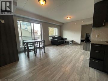 Waterloo condo for rent - A living room with a dining table and chairs.