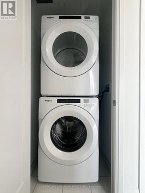 Toronto (Mount Pleasant West) condo for rent - Two white Whirlpool washing machines in a small laundry room.