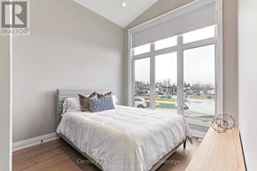 Blue Mountains apartment for rent - A bedroom with a large bed and a view of the street outside.