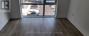 Hamilton (Waterdown) condo for rent - A room with a view of a parking lot through a glass door.