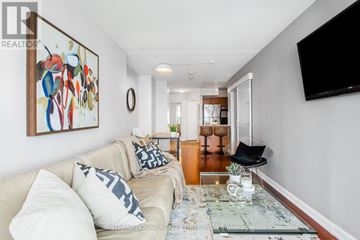 Toronto (Church-Yonge Corridor) condo for rent - A living room with a couch, a coffee table, and a painting on the wall.
