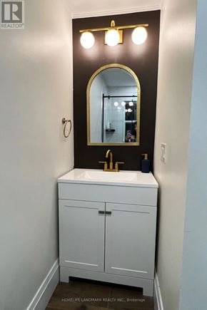 Niagara Falls (Hospital) apartment for rent - A bathroom with a sink and a mirror above it.