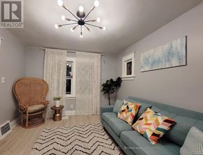 Niagara Falls (Hospital) apartment for rent - A living room with a couch, chair, and a painting on the wall.