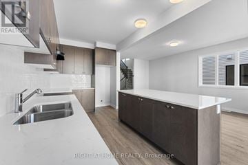 Ottawa townhouse for rent - A modern kitchen with a sink and cabinets.