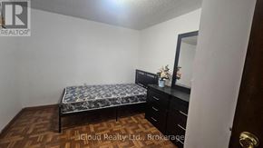 Toronto (Wexford-Maryvale) apartment for rent - A bedroom with a bed, dresser, and mirror.