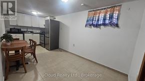 Toronto (Wexford-Maryvale) apartment for rent - A kitchen with a table and chairs in the foreground and a refrigerator in the background.