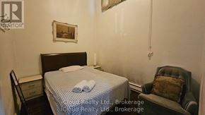 Toronto (Wexford-Maryvale) apartment for rent - A bedroom with a bed, chair, and a painting on the wall.