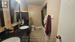 Toronto (Wexford-Maryvale) apartment for rent - A bathroom with a sink, mirror, toilet, and a towel hanging on the wall.